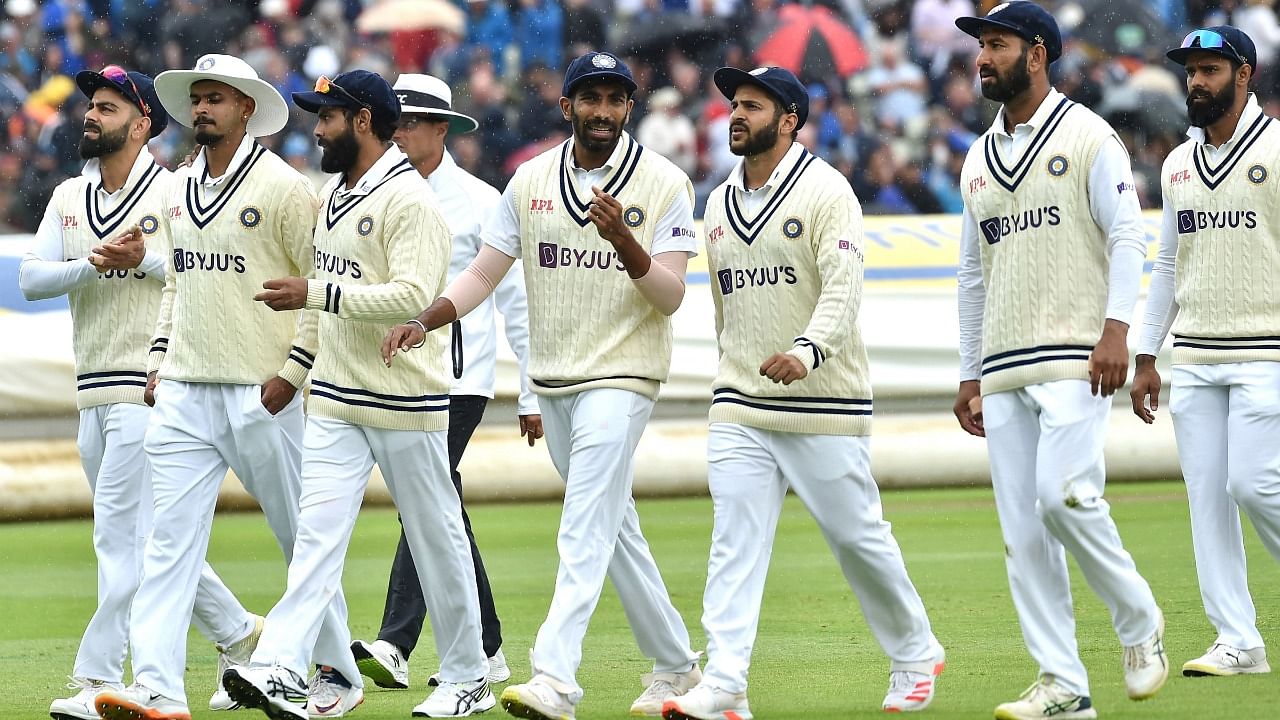 India players leave the field after rain stops play during the second day of the fifth cricket test match between England and India at Edgbaston in Birmingham, England. Credit: AP Photo