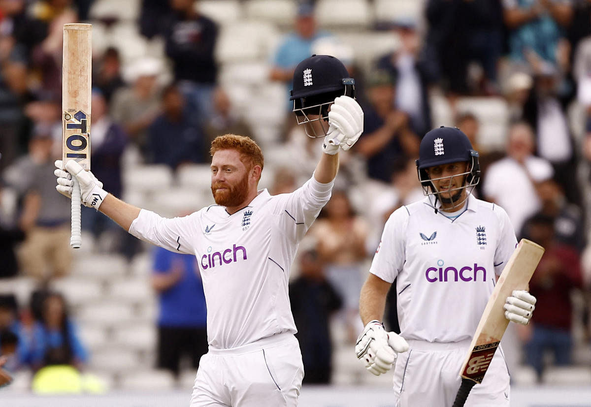 England's Jonny Bairstow celebrates reaching his century with Joe Root Action. Credit: Reuters Photo