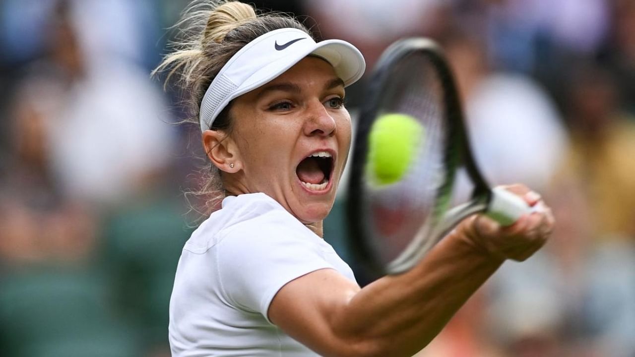 Romania's Simona Halep returns the ball to Spain's Paula Badosa during their round of 16 women's singles tennis match on the eighth day of the 2022 Wimbledon Championships at The All England Tennis Club in Wimbledon. Credit: AFP Photo