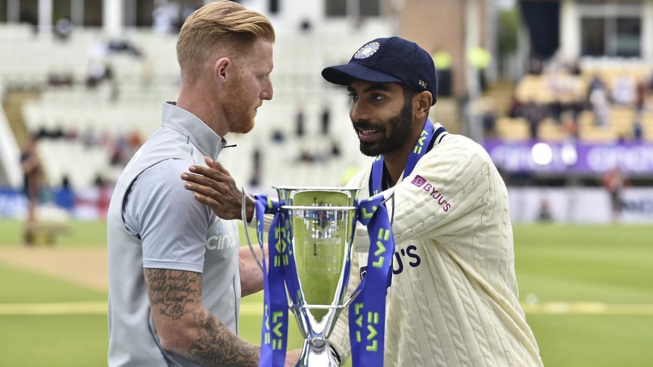 England's captain Ben Stokes, left, and India's captain Jasprit Bumrah shake hands after receiving the winners trophy after England won the fifth cricket test match. Credit: AP Photo