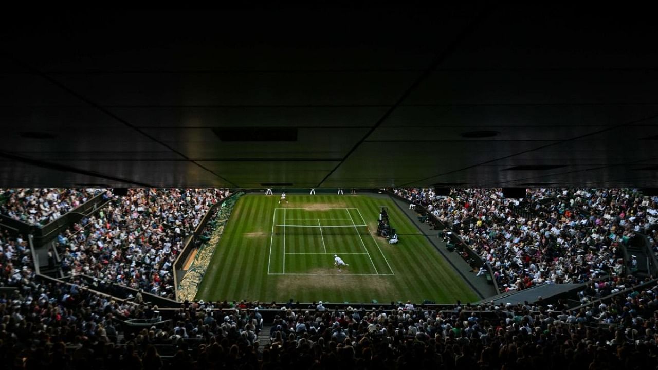 Netherlands' Botic Van De Zandschulp serves to Spain's Rafael Nadal during their round of 16 men's singles tennis match on the eighth day of the 2022 Wimbledon Championships at The All England Tennis Club in Wimbledon, southwest London, on July 4, 2022. Credit: AFP Photo