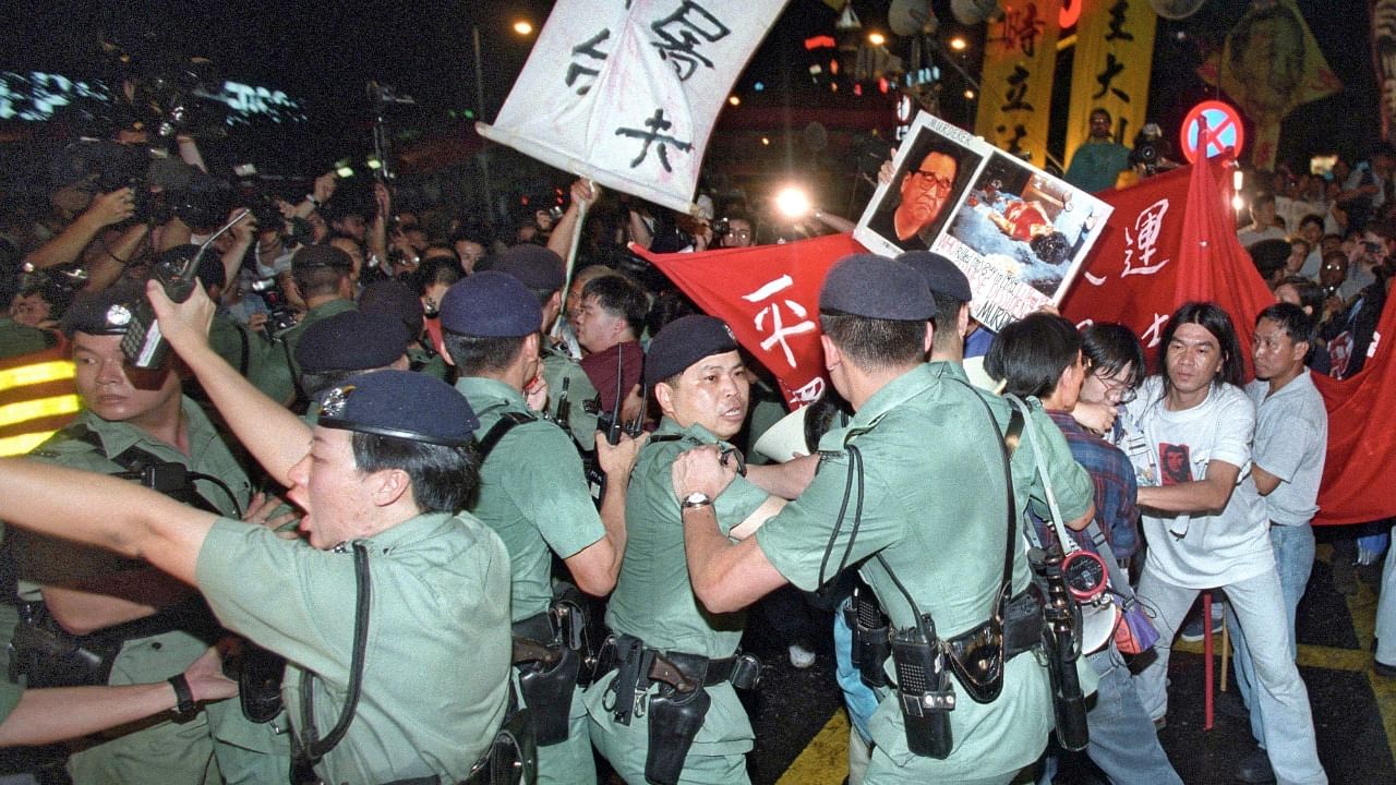 Protesters trying to push through police lines to march towards the venue in Hong Kong where handover ceremonies are taking place as China formally takes control of the territory from Britain in 1997. Credit: AFP File Photo