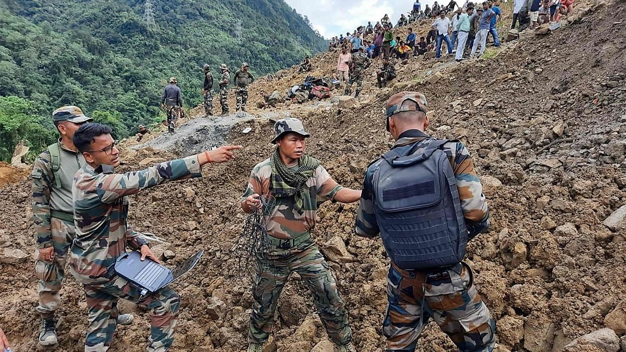 Soldiers and disaster relief teams search for survivors and victims at Noney landslide site. Credit": AFP Photo/Indian Army