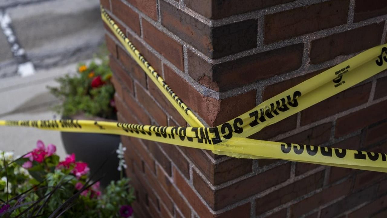 Crime scene tape is seen near the scene of a mass shooting at a Fourth of July parade, on July 6, 2022 in Highland Park. Credit: AFP Photo