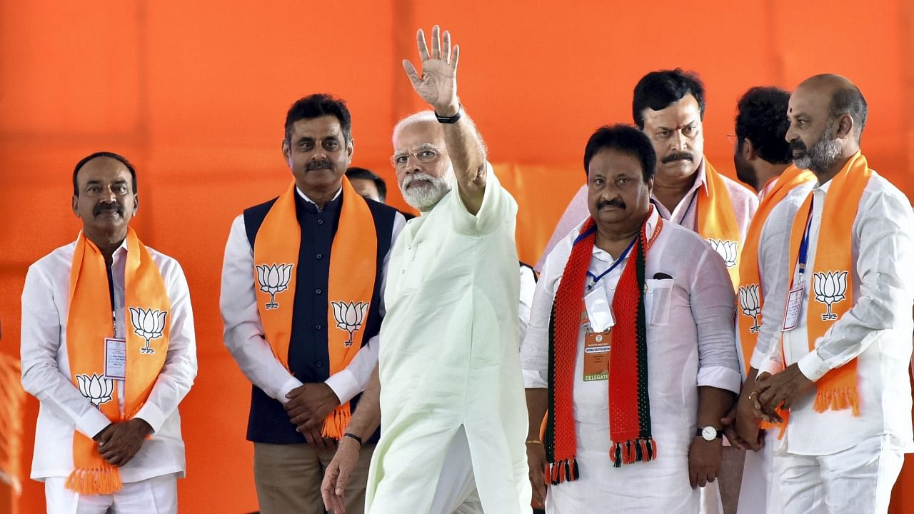 Prime Minister Narendra Modi waves towards supporters during a public meeting, in Hyderabad. Credit: PTI Photo