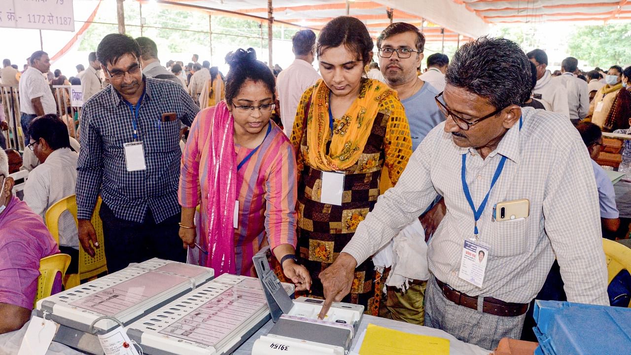 Poll officials collect Electronic Voting Machines (EVM) and other election material from a distribution centre, on the eve of local bodies' elections, in Jabalpur. Credit: PTI Photo