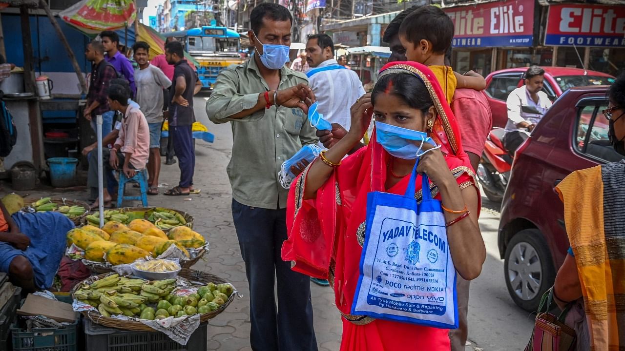 Health workers distribute face masks as a safety protocol to curb the spread of Covid-19. Credit: AFP Photo
