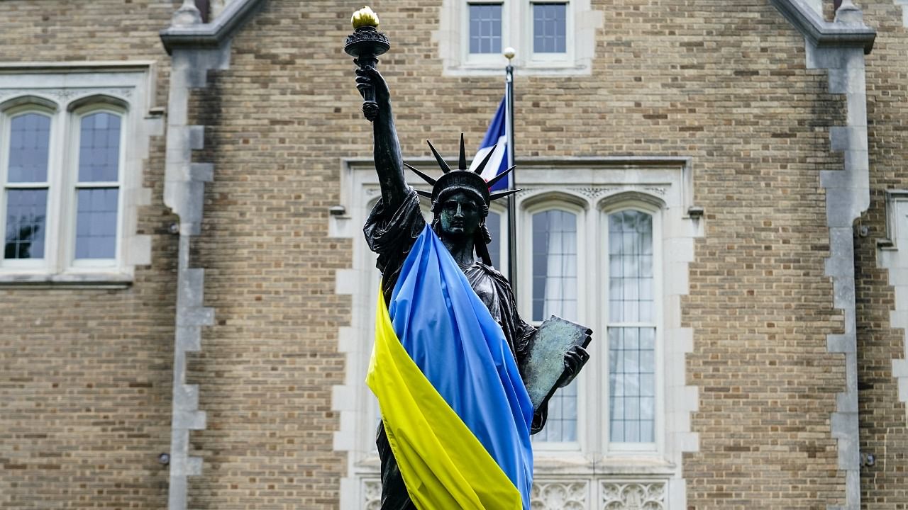 A scaled model of the Statue of Liberty is seen draped in a Ukrainian flag outside of the French Embassy in Washington. Credit: Reuters Photo