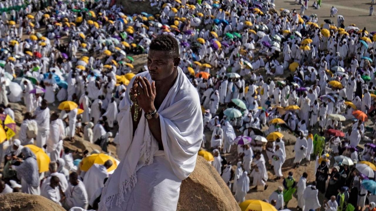 A Muslim pilgrim prays atop Mount Arafat, also known as Jabal al-Rahma (Mount of Mercy), southeast of the holy city of Mecca, during the climax of the Hajj pilgrimage. Credit: AFP Photo