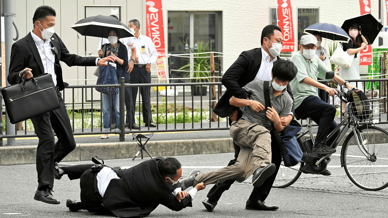 Tetsuya Yamagami, holding a weapon, is detained near the site of gunshots in Nara, western Japan. Credit: AFP Photo