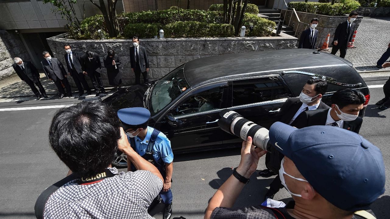 A car transporting the body of former Japanese prime minister Shinzo Abe arrives at his residence in Tokyo. Credit: AFP Photo