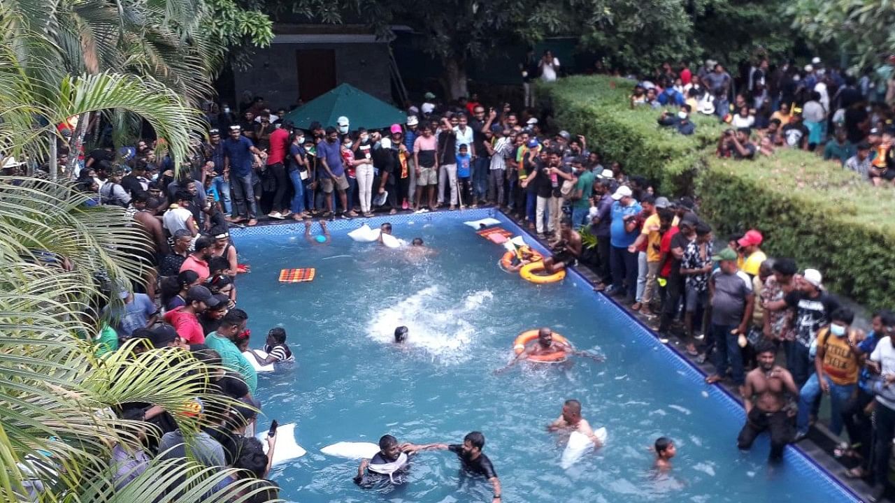 Protestors demanding the resignation of Sri Lanka's President Gotabaya Rajapaksa swim in a pool inside the compound of Sri Lanka's Presidential Palace in Colombo. Credit: AFP Photo