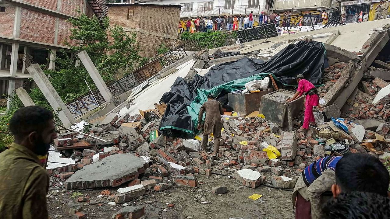 Debris of a four-storey building that collapsed after heavy rainfall, at Chopal in Shimla district. Credit: PTI Photo