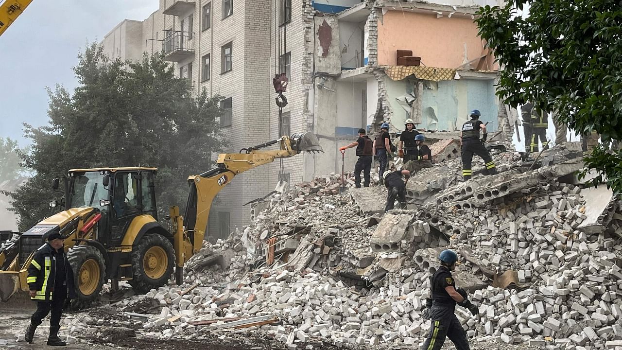 Firefighters and members of a rescue team clear the scene after a building was partialy destroyed following shelling, in Chasiv Yar, eastern Ukraine. Credit: AFP Photo