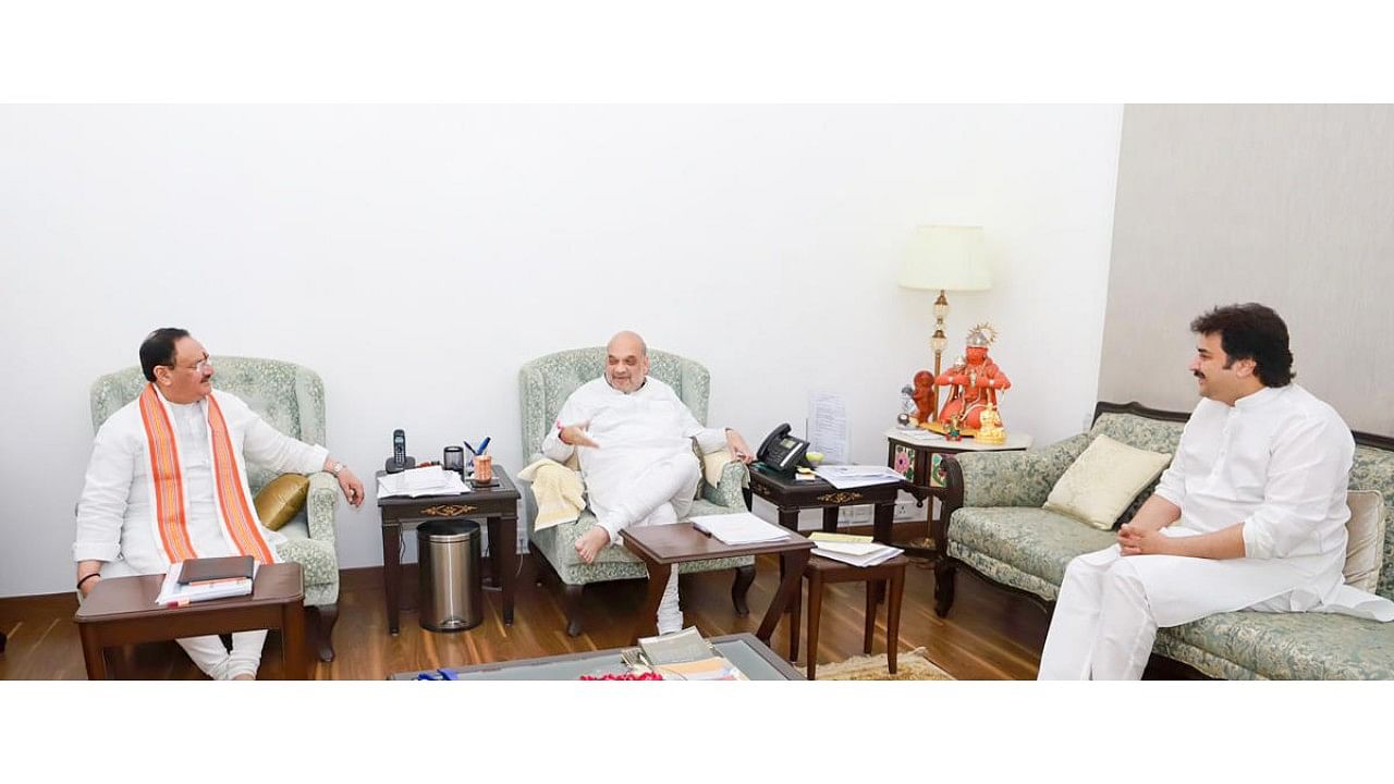 Union Home Minister Amit Shah and BJP National President J P Nadda with expelled Congress leader Kuldeep Bishnoi during their meeting in New Delhi. Credit: PTI Photo
