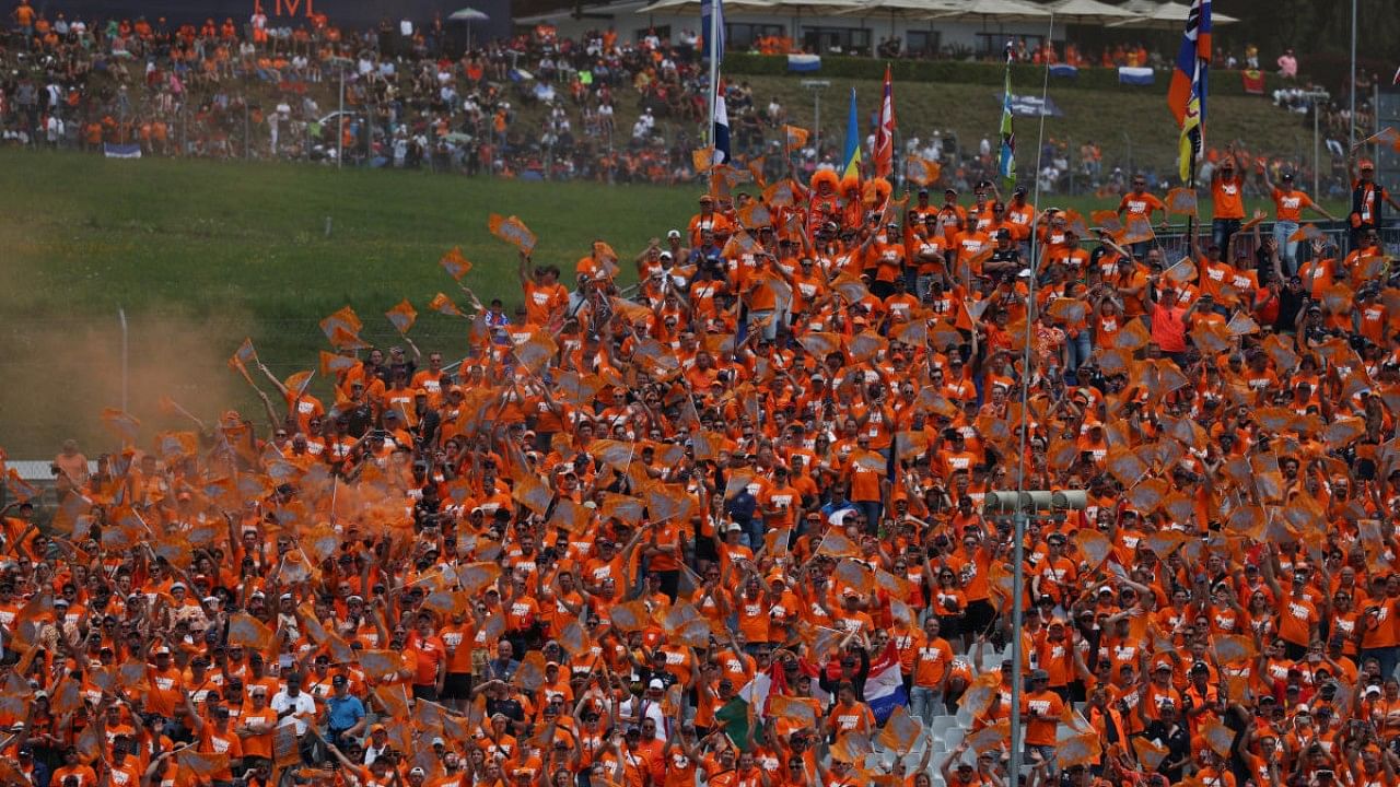 Fans are pictured wearing orange in support of Red Bull's Max Verstappen ahead of the Grand Prix. Credit: Reuters Photo