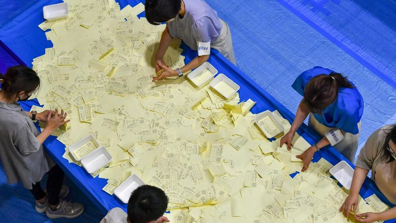 Officials of the election administration committee count the votes for Japan's upper house election in Tokyo. Credit: AFP Photo