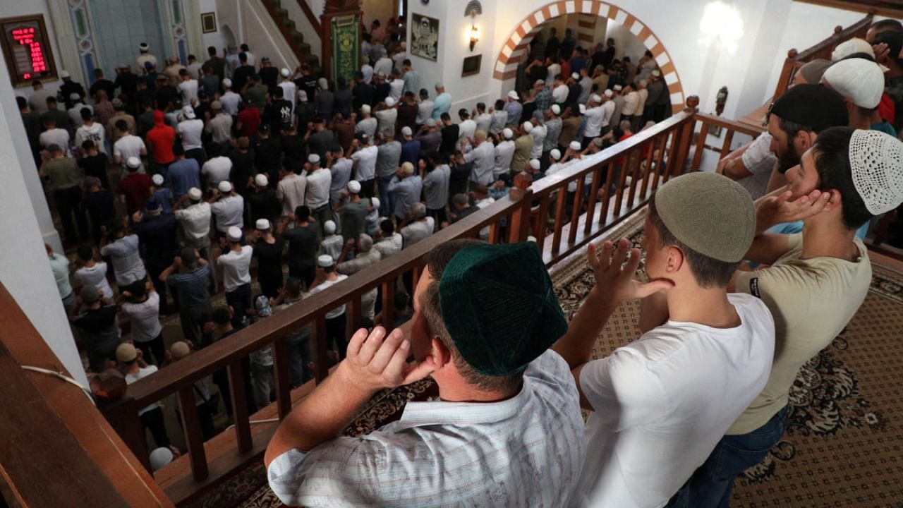Muslims attend Eid al-Adha prayers at the Juma-Jami Mosque in Yevpatoriya. Credit: Reuters photo
