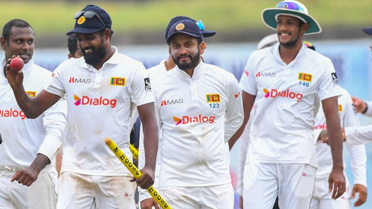 Sri Lanka's players celebrate their win in the second cricket Test match against Australia. Credit: AFP Photo