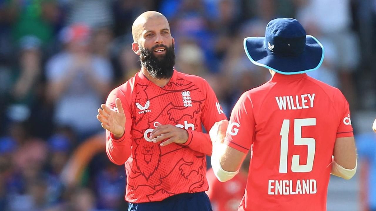 Moeen Ali (L) celebrates with David Willey after taking the wicket of Suryakumar Yadav during the '3rd Vitality IT20' Twenty20 International cricket match between England and India. Credit: AFP Photo