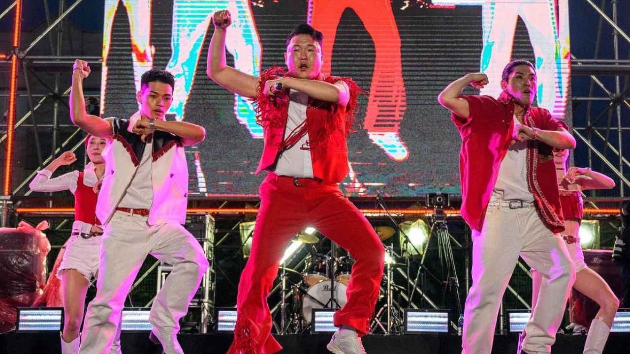  In this file picture taken on May 27, 2022, South Korean singer and producer Psy (C) performs his biggest hit song, ‘Gangnam Style’, during a concert at an outdoor venue in the grounds of the Korea University in Seoul. Credit: AFP Photo