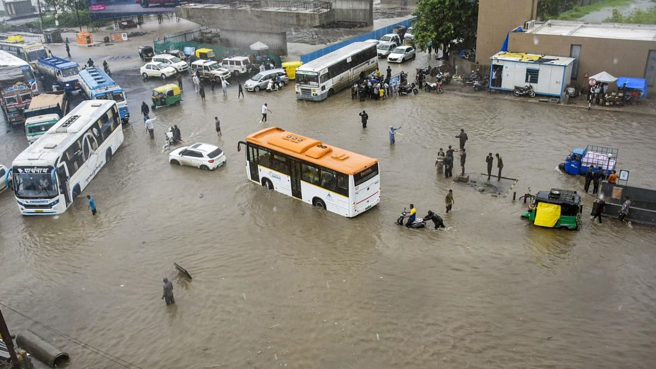 Vehicles wade through the waterlogged Ring Road after monsoon rains, in Rajkot, Tuesday, July 12, 2022. Credit: PTI Photo