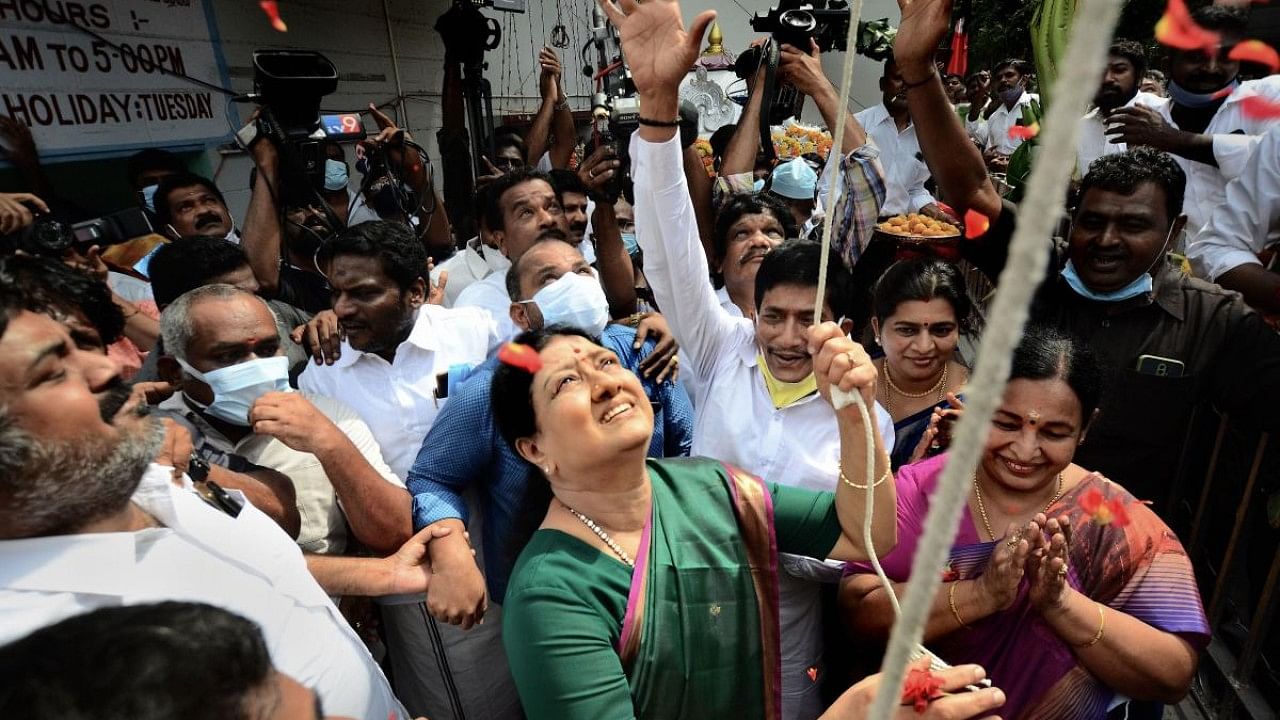 Expelled AIADMK leader VK Sasikala hoists party flag at MG Ramachandran (MGR) memorial house on the occasion of AIADMK's golden jubilee and foundation day celebrations, at T Nagar, in Chennai. Credit: PTI