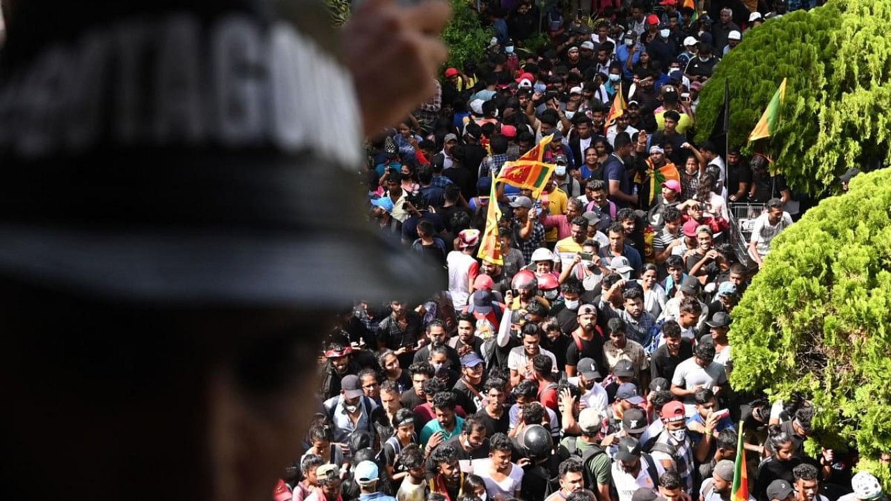 Demonstrators gather in the lawn of the office building of Sri Lanka's prime minister during an anti-government protest, in Colombo. Credit: AFP Photo