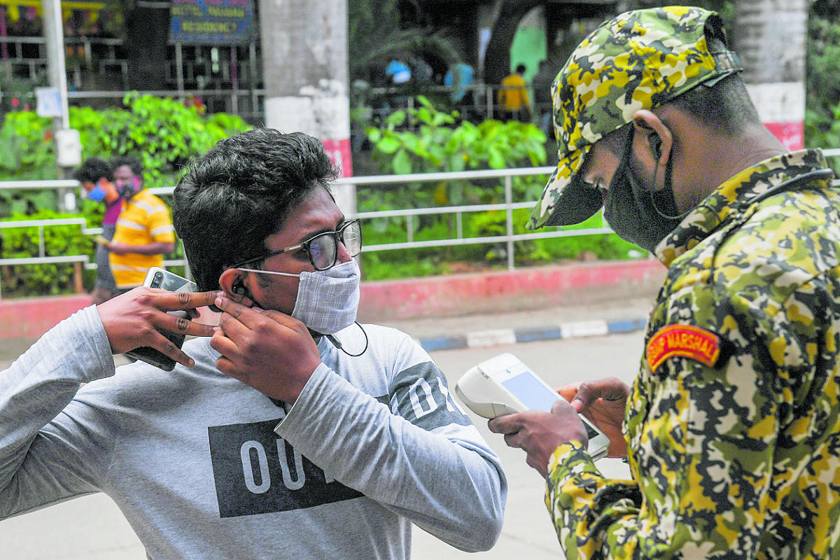 The government has urged people to remain cautious and wear masks always. Credit: DH Photo