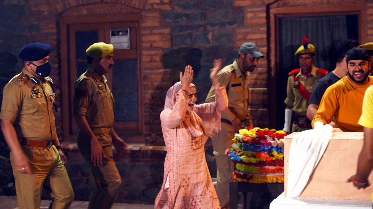 A relative wails during the wreath laying ceremony of police officer Mushtaq Ahmad, who was killed in a militant attack at Lal Bazar, at District Police Lines (DPL) in Srinagar, Tuesday, July 12, 2022. Two constables were also injured in the attack. Credit: PTI Photo