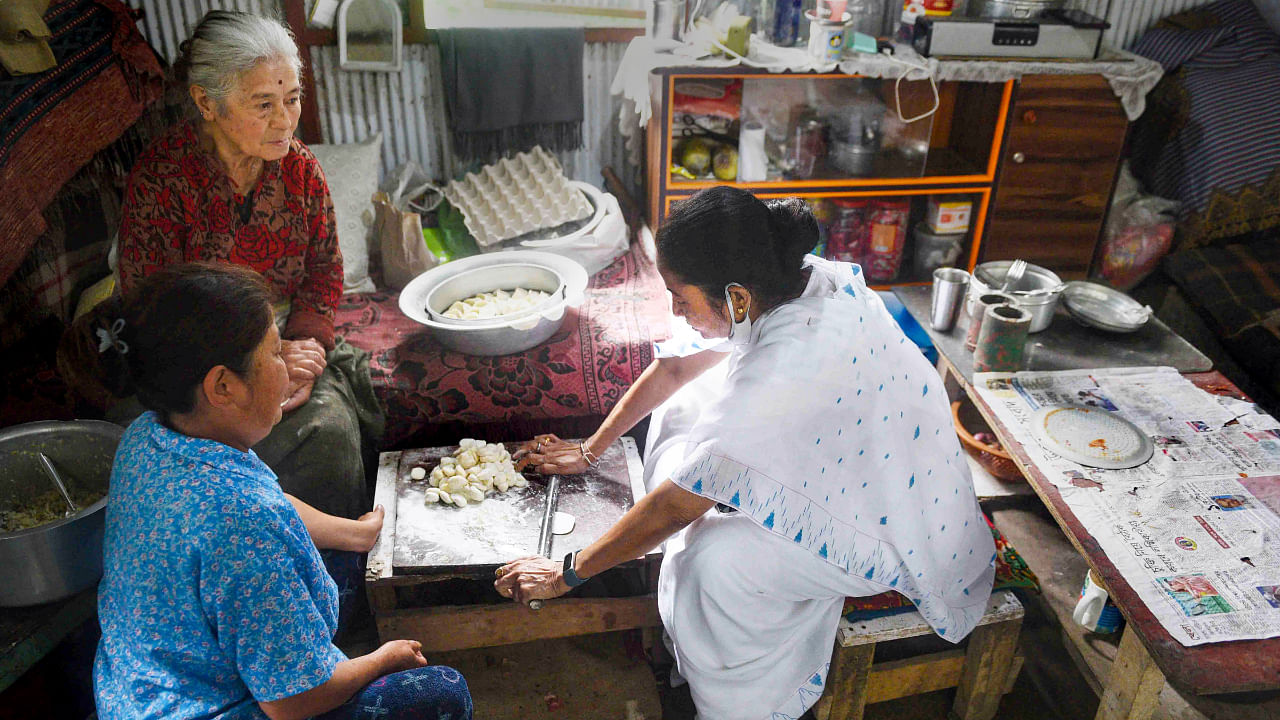 Mamata Banerjee (right) making momos in Darjeeling, July 14, 2022. Credit: PTI Photo