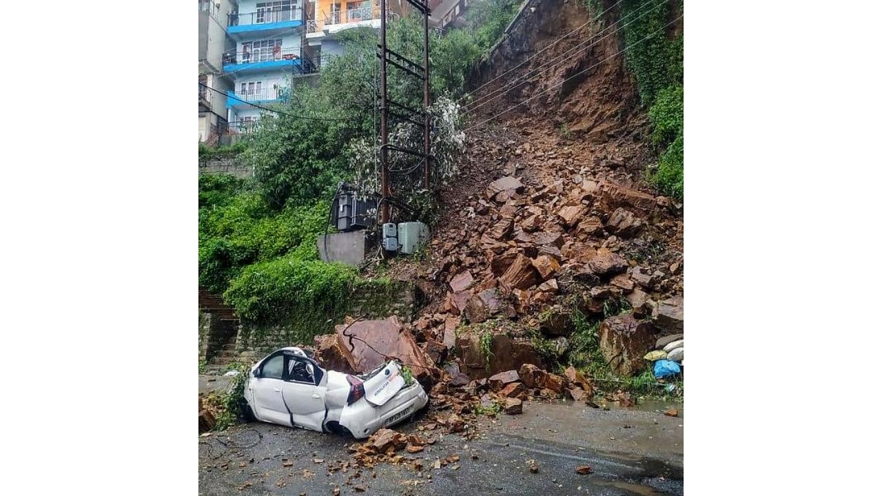 A car buried under the debris after a landslide due to heavy rainfall, at Vikasnagar in Shimla on Wednesday, July 28, 2021. Credit: PTI