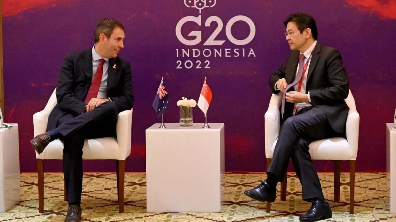 Australian Treasurer Jim Chalmers (L) sits with Singapore Minister of Finance and Deputy Prime Minister Lawrence Wong (R). Credit: AFP Photo