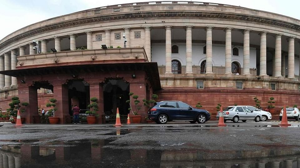 The Indian Parliament building is reflected in a puddle after heavy rain during the monsoon session of the Indian Parliament in New Delhi. Credit; AFP File Photo