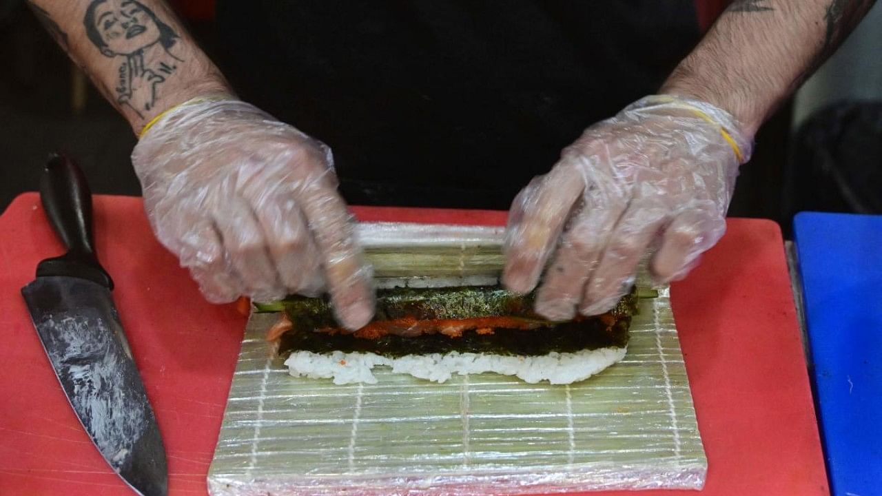 Ukrainian sushi chef Igor Bezux, 23, prepares one of his creations at the Sushi Yakuza restaurant, center Kramatorsk, on July 15, 2022, amid the Russian invasion of Ukraine. Credit: AFP Photo