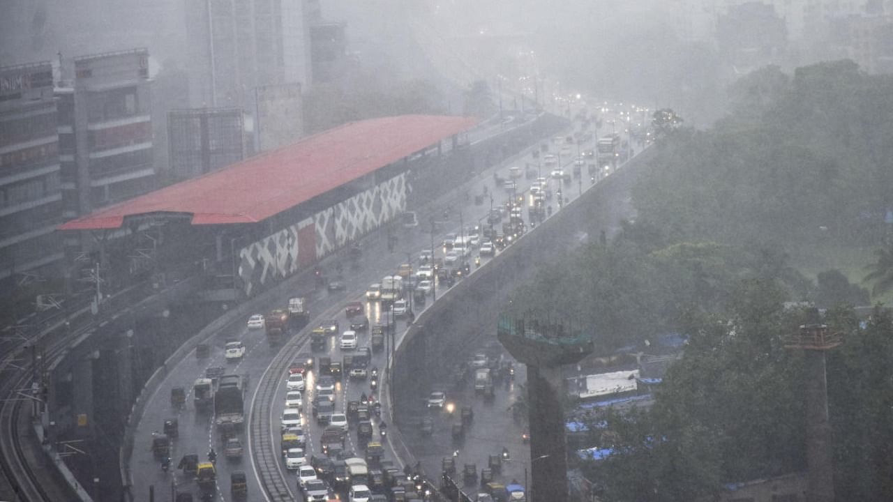 Vehicles ply on a road amid monsoon rains, in Mumbai. Credit: PTI Photo