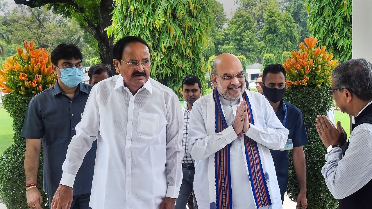 Vice President M Venkaiah Naidu and Union Home Minister Amit Shah arrive for a lunch hosted by Naidu, in New Delhi. Credit: PTI Photo