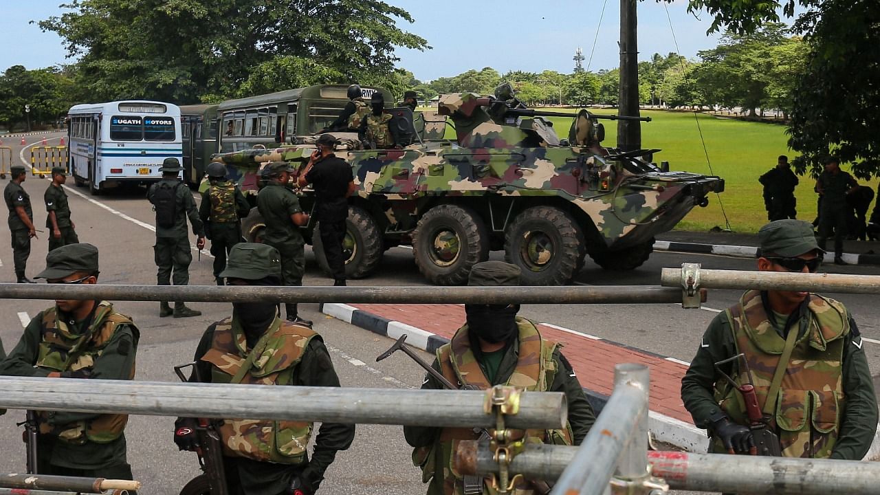 Sri Lanka army soldiers stands guard near the parliament building in Colombo. Credit: AFP Photo