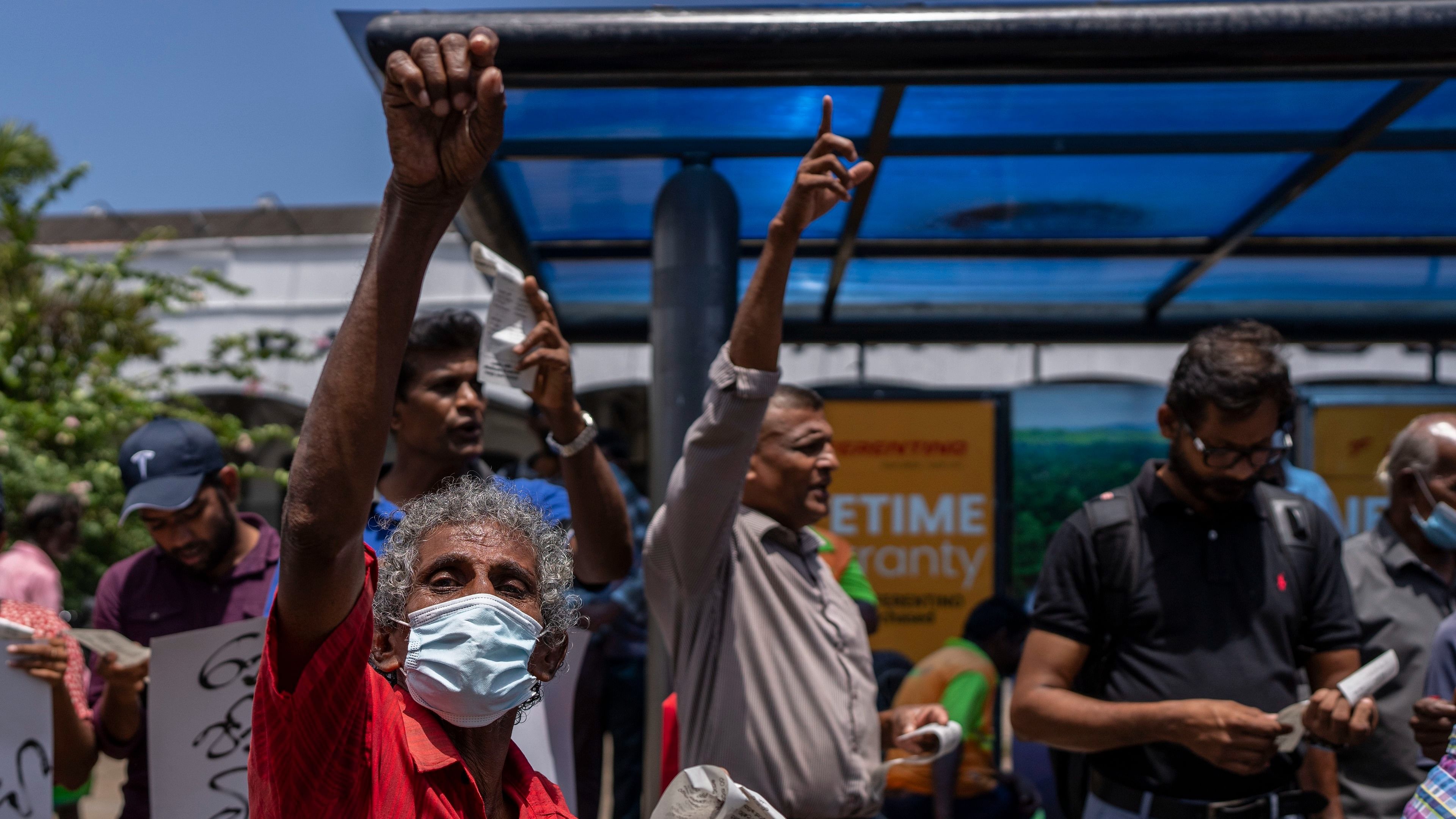 Trade union representatives and activists shout slogans during a protest against Sri Lanka's acting president Ranil Wickremesinghe in Colombo, Sri Lanka. Wickremesinghe on Monday declared a state of emergency giving him broad authority amid growing protests demanding his resignation two days before the country's lawmakers are set to elect a new president. Credit: AP/PTI