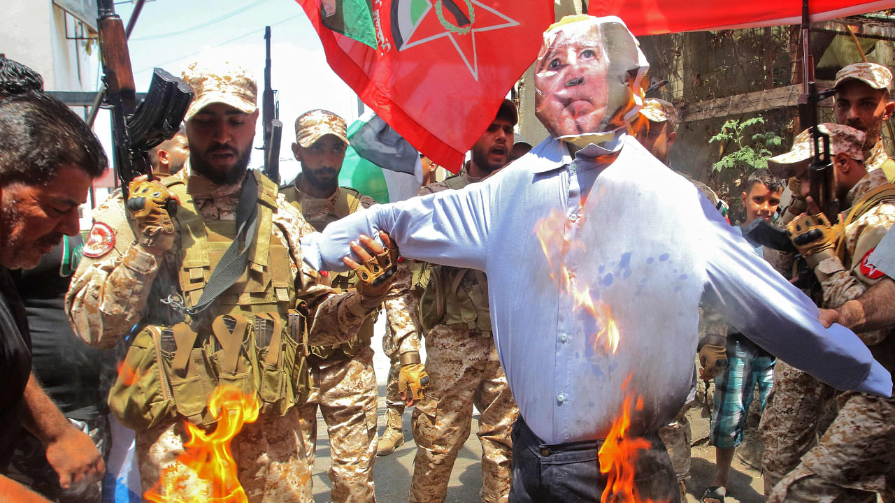 Fighters affiliated with the Democratic Front for the Liberation of Palestine (DFLP) burn an effigy of US President Joe Biden on July 15, 2022. Credit: AFP Photo