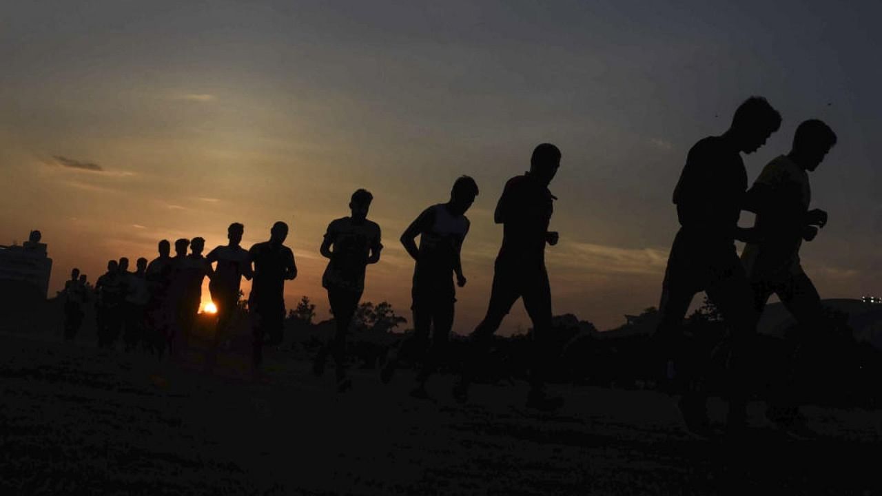 Youngsters run during a training session organised for the preparation of Agnipath examination, at Gandhi Maidan in Patna, Thursday, July 7, 2022. Credit: PTI Photo