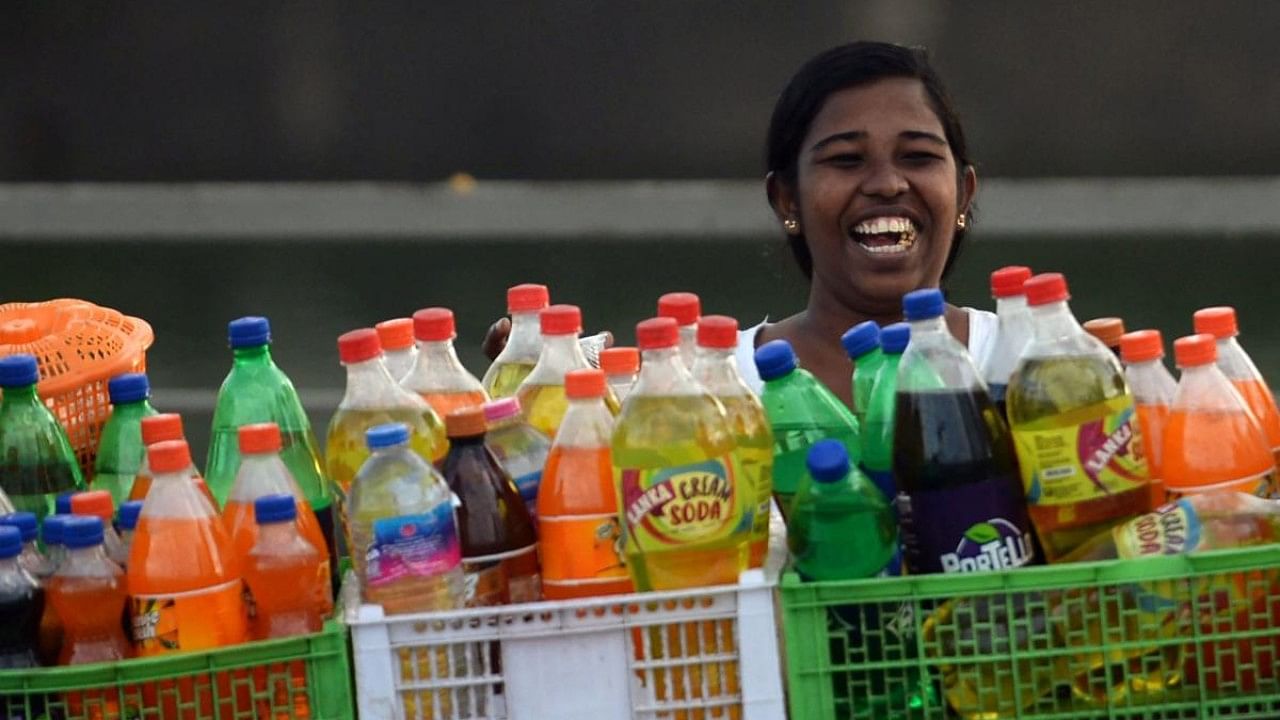 A 29% compensation cess will increase the GST revenue from aerated drinks by 27% (Rs 25.8 billion) and lead to an increase in the price from the current level of Rs 60 per litre to Rs 67. Credit: AFP File Photo