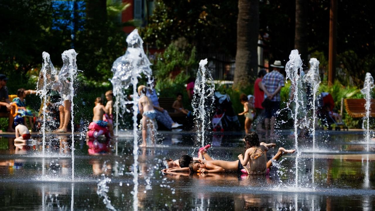 Children cool off in a fountain in Nice as a heat wave hits France. Credit: Reuters Photo