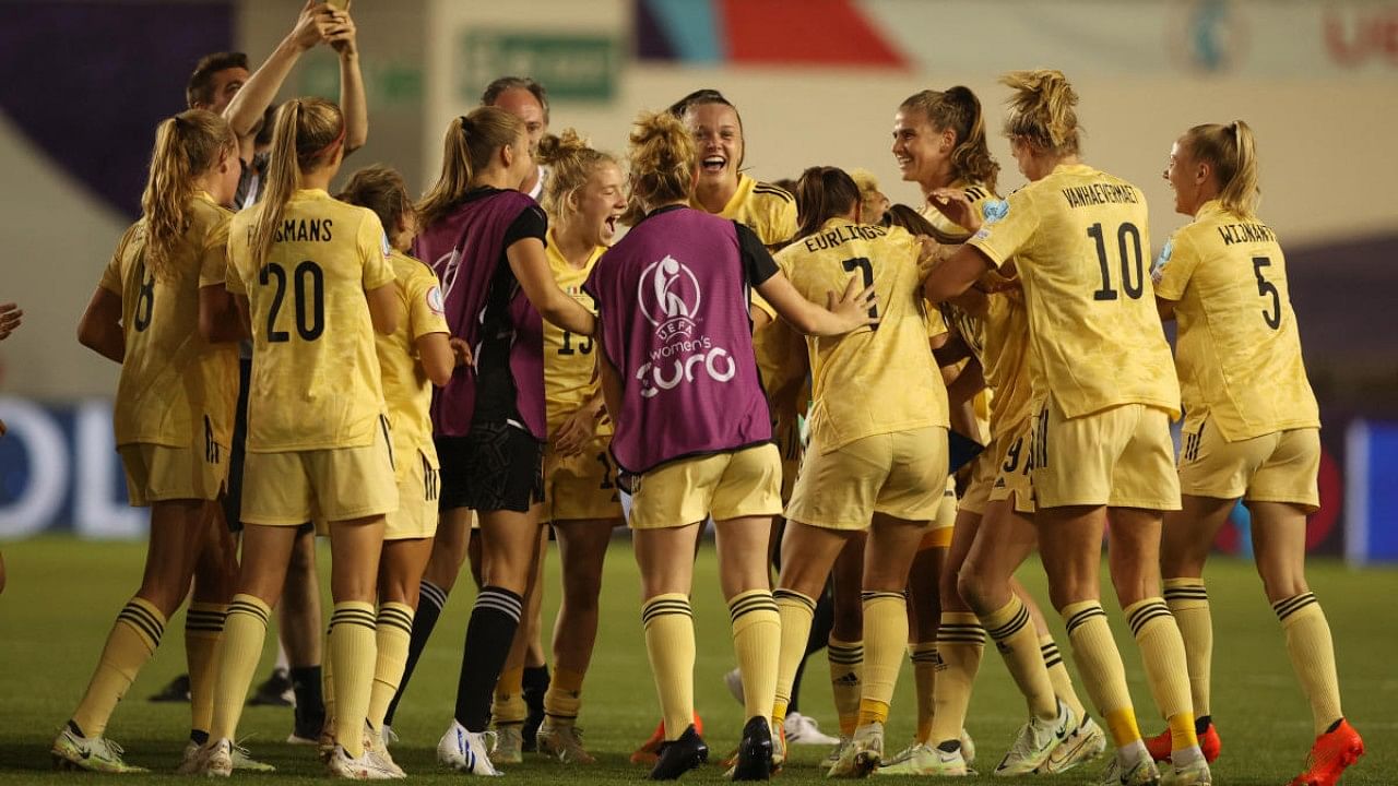 Belgium players celebrate after progressing to the quarter finals. Credit: Reuters Photo