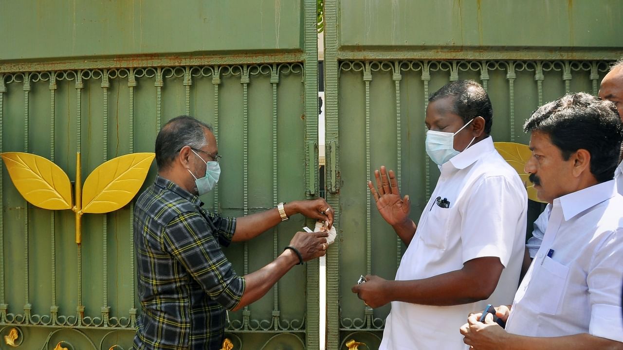 AIADMK party headquarters seal being removed by officials of the Revenue Department, in Chennai. Credit: PTI Photo