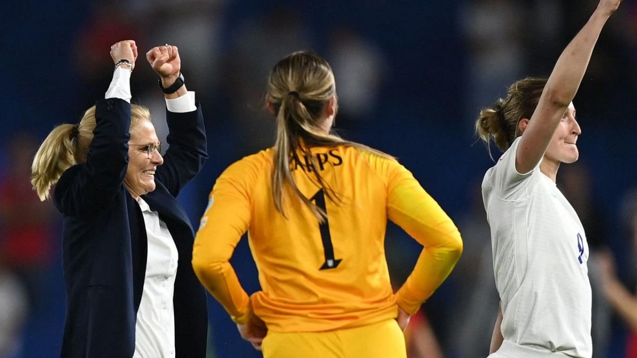 England's head coach Sarina Wiegman (L) and England's striker Ellen White (R) celebrate their win. Credit: AFP Photo