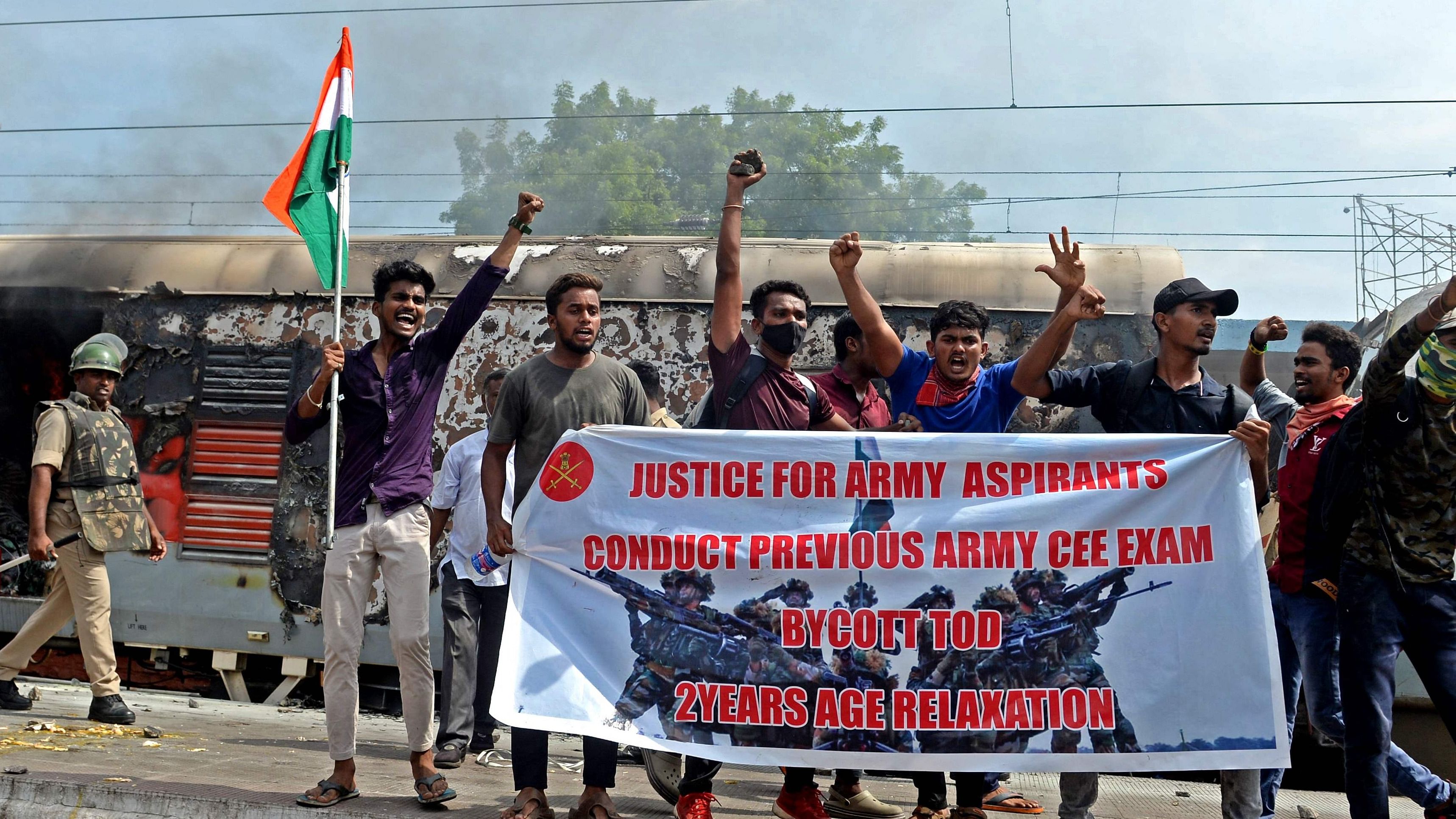 Protesters shout slogans after setting a train on fire during a demonstration against the government's new 'Agnipath' recruitment scheme for the army, navy, and air forces at a railway station in Secunderabad on June 17, 2022. Credit:AFP Photo
