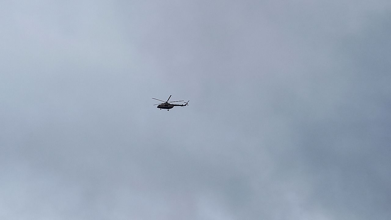 A military helicopter flies over the main military base after heavy gunfire was heard early on Friday, in Kati. Credit: Reuters Photo