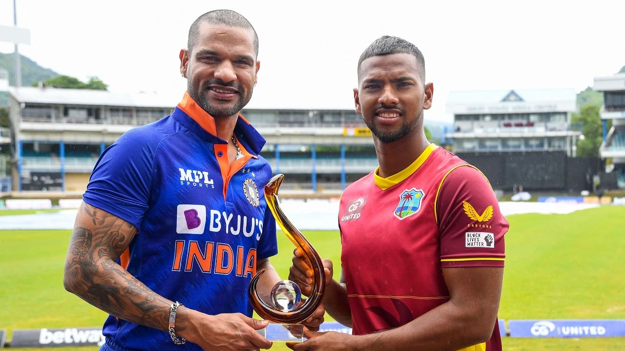 Shikhar Dhawan (L) of India and Nicholas Pooran (R) of West Indies with the ODI trophy one day before the 1st ODI match between West Indies and India at Queens Park Oval. Credit: AFP Photo