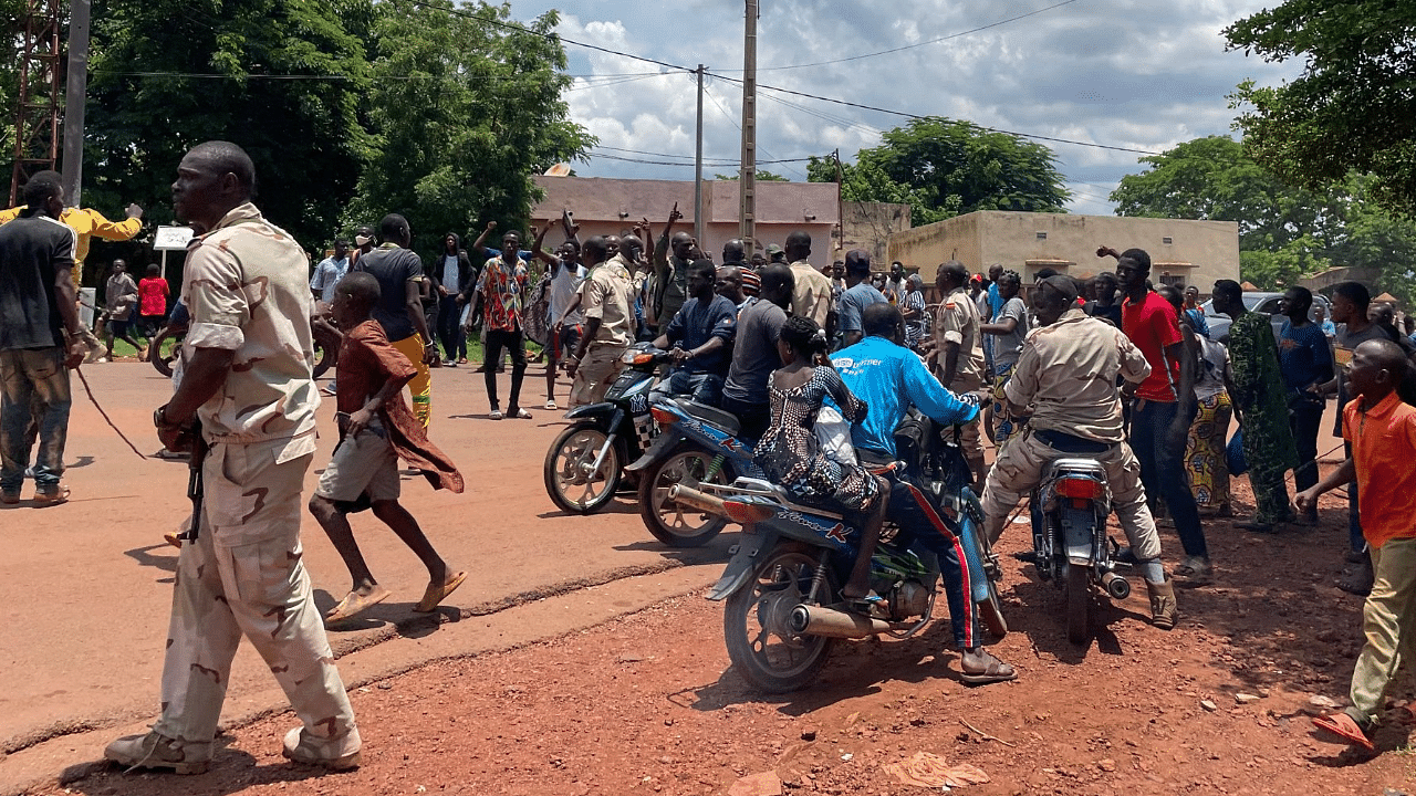  A crowd gathers around a man (not seen) suspected of taking part in thwarted "terrorist" after being beaten by a crowd, in front of the military base in Kati, Mali. Credit: AFP Photo